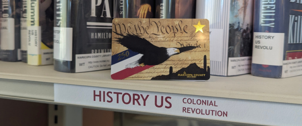 America 250 themed library card on a history section shelf