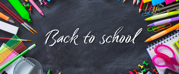 Back to school written in chalk on blackboard surronded by school supplies