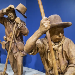 Two statues of male labourers