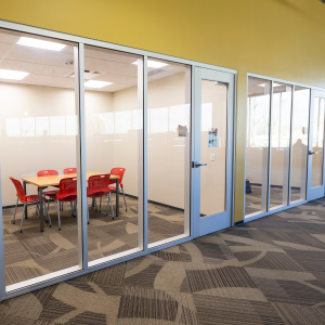 Room with table and chairs behind glass door