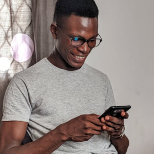 man looking at his smartphone, smiling
