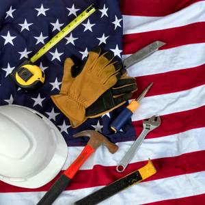 USA Flag with construction tools laid on top